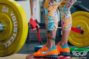 The Girl Lifts a Barbell Using Laso Straps