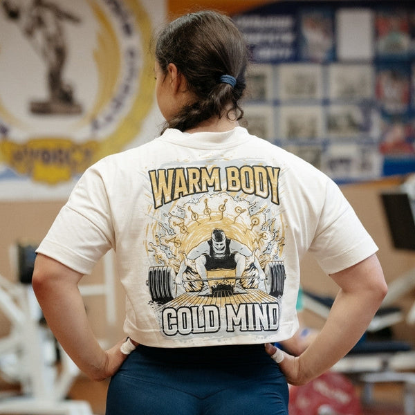 Person wearing a beige Women's Cropped T-shirt - Lift Off in a gym setting - Warm Body Cold Mind