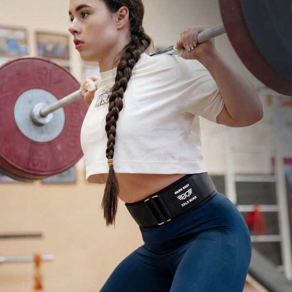 Woman lifting weights with a Black 4″ weightlifting Nylon Belt 2.0 in a gym setting  - Warm Body Cold Mind